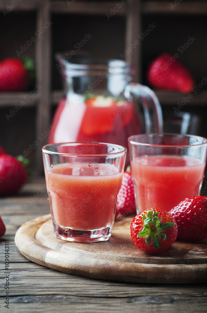 Sweet strawberry juice on the wooden table Sweet strawberry juice on the wooden table