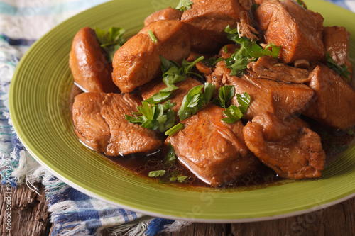 Delicious Filipino Food: Adobo chicken with herbs close-up. horizontal
