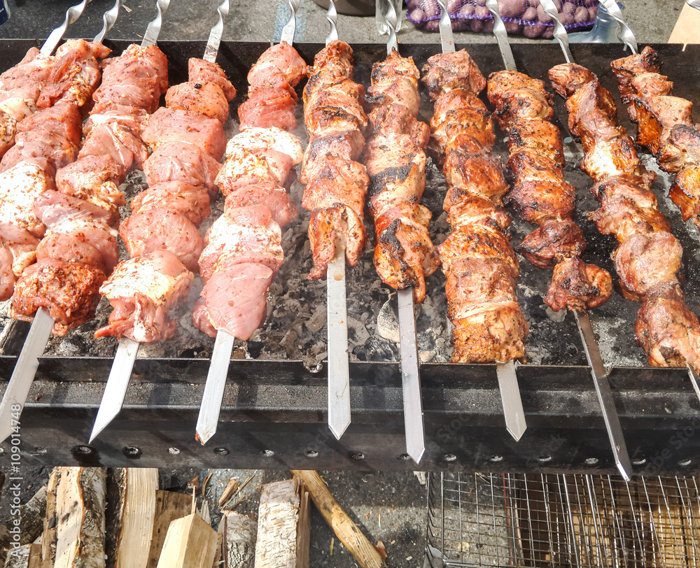 Street food. Shish kebab is prepared on the grill.