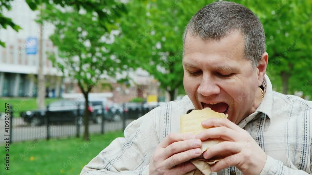 Portrait of a very hungry man eating junk food Portrait of a very hungry man eating junk food