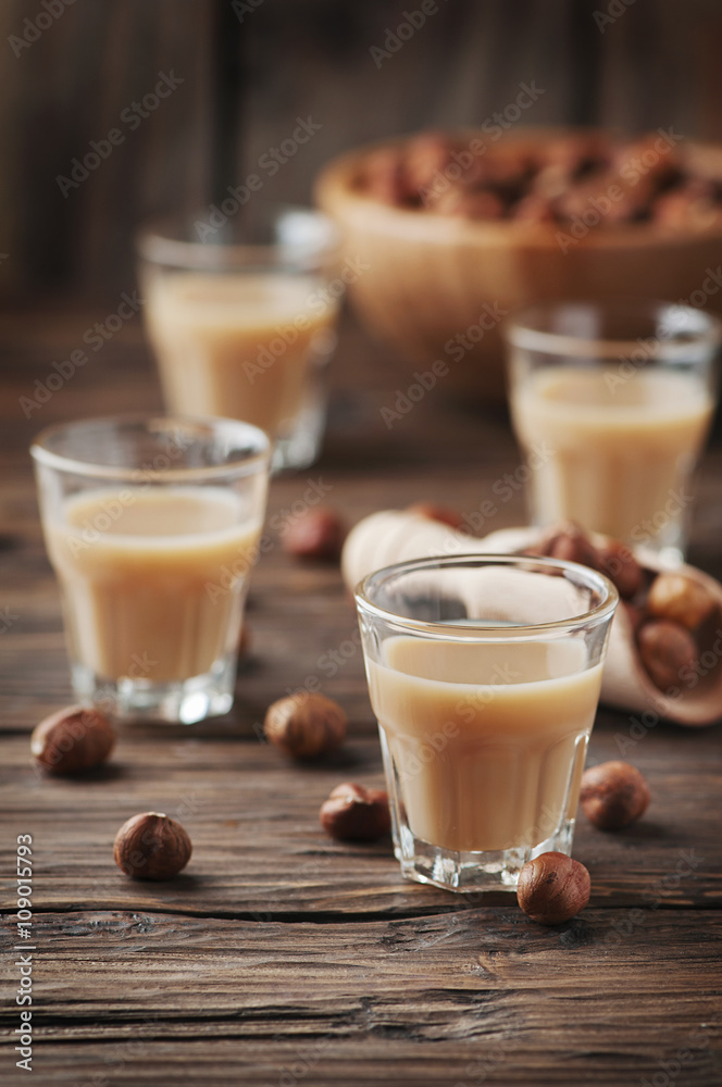 Italian traditional hazelnut liqueur on the wooden table Italian traditional hazelnut liqueur on the wooden table