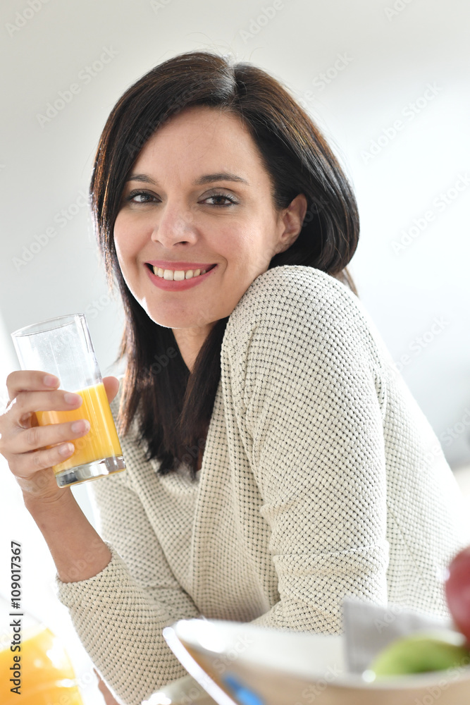 Portrait of mature woman drinking orange juice Portrait of mature woman drinking orange juice