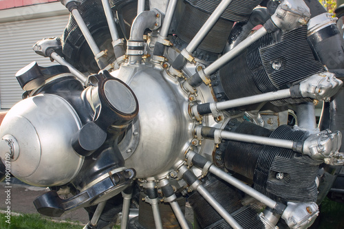 Classic vintage airplane motor engine. Many cylinders around the propeller.