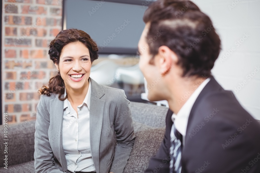 Cheerful business professionals sitting on sofa Cheerful business professionals sitting on sofa