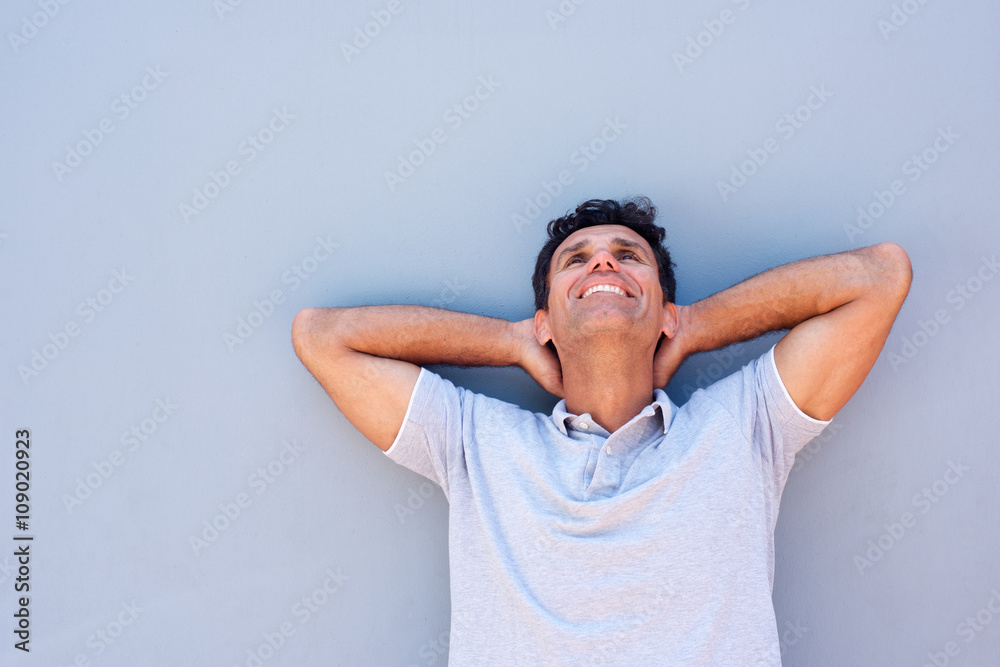 Older man smiling with hands behind head Older man smiling with hands behind head
