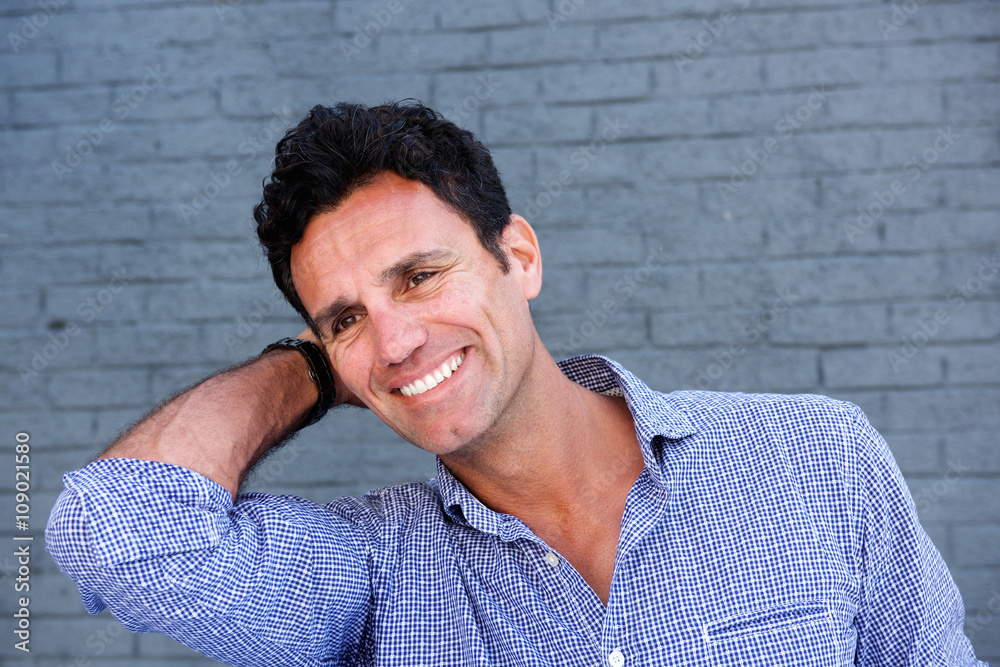 Close up portrait of a handsome man smiling with hand Close up portrait of a handsome man smiling with hand