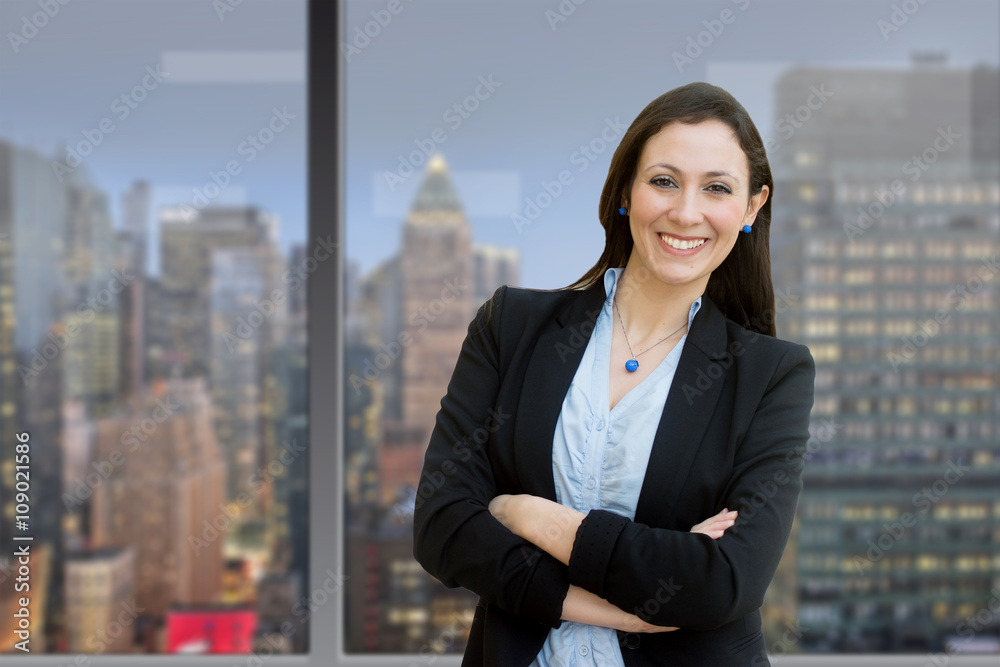 Successful business woman looking confident and smiling, inside Successful business woman looking confident and smiling, inside