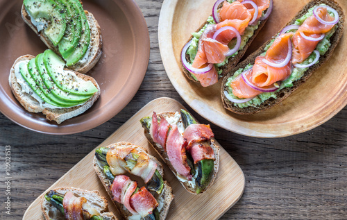 Toasts with avocado and different toppings