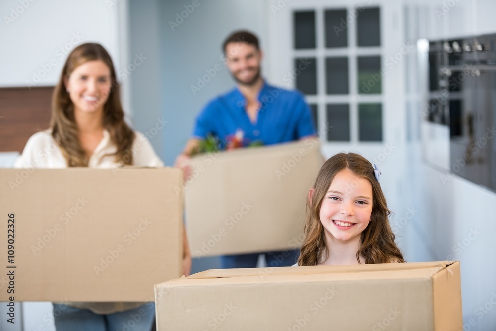 Portrait of family holding boxes Portrait of family holding boxes