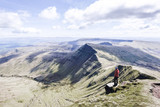 A girl on top of a mountain looking at the panorama, Pen Y Fan