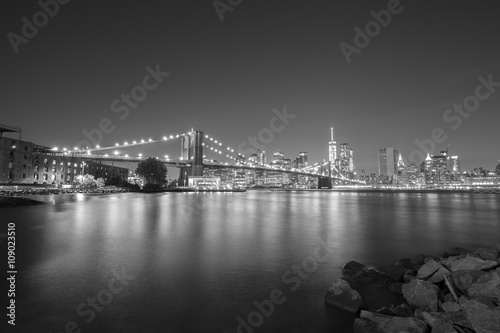 Black and white picture of New York City skyline with Brooklyn Bridge, USA.