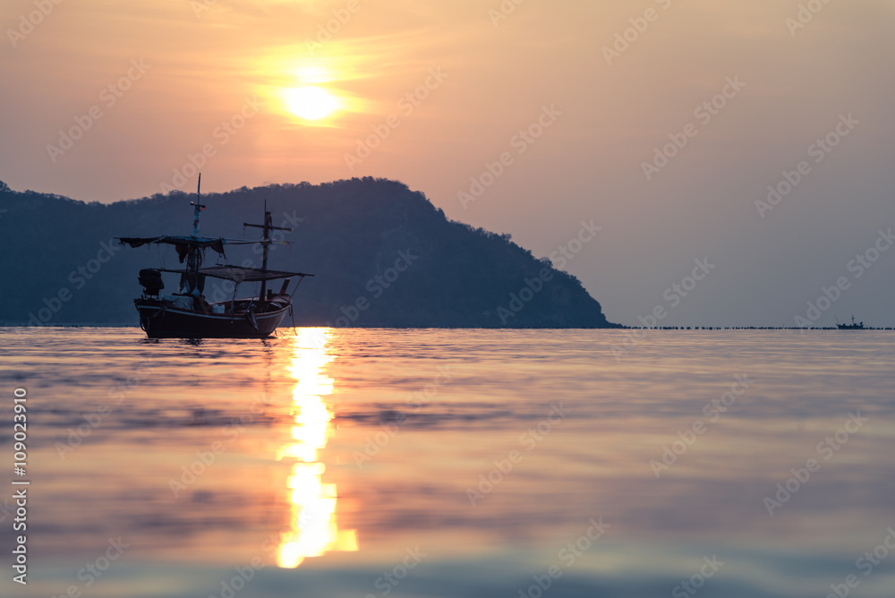 Traditional thai boat at sunset on sea in Thailand