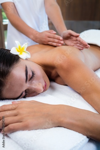 Masseuse giving massage to relax woman at spa 