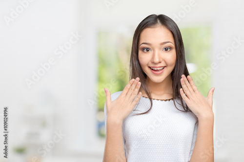 Surprised businesswoman with hands up amazed or shocked by unexpected news