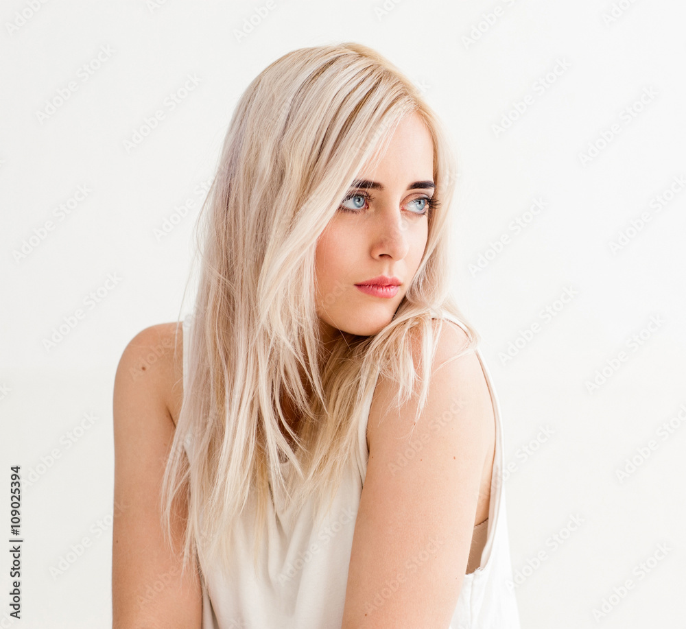 Woman with nude makeup on white background. Blonde calm girl