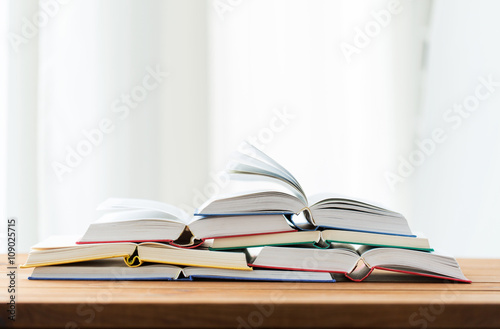 close up of books on wooden table
