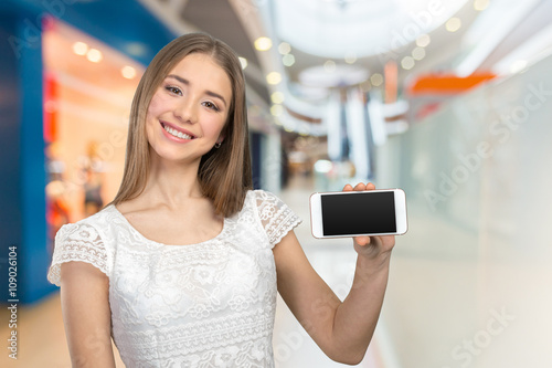 Happy pretty woman showing a blank smart phone screen