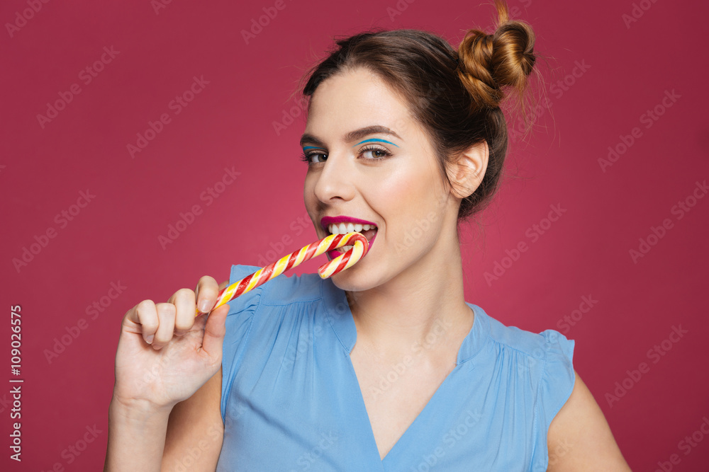 Closeup of beautiful smiling young woman with candy cane Closeup of beautiful smiling young woman with candy cane