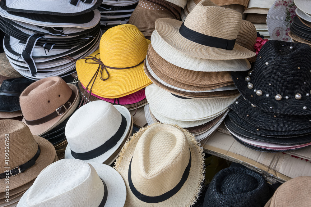 Variety of straw  hats selling in the flea market 