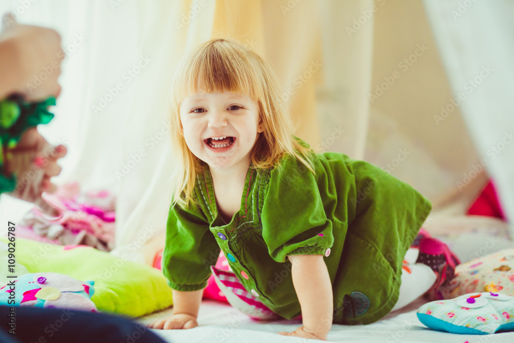 Cheerful little girl in the beautiful dress