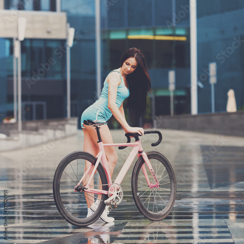 Young slim sexy sportive woman on bicycle