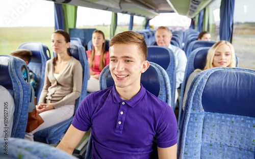 happy young man sitting in travel bus or train