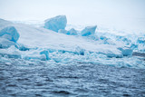 Coast Antarctica with ices and icebergs of unusual forms, colors