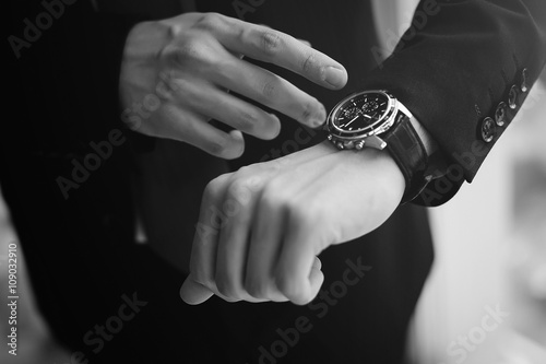 Monochrome picture of boss looking up on his watches