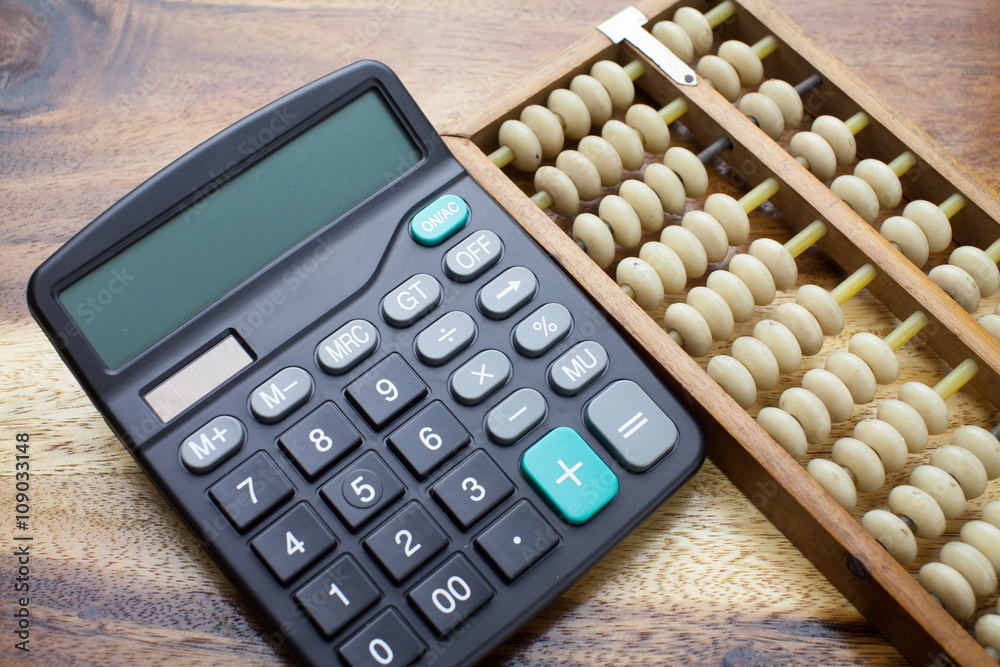 Abacus,calculator with wooden table background Abacus,calculator with wooden table background