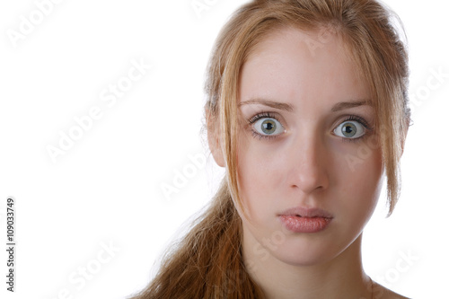 girl with eyes bulging with surprise on a white background