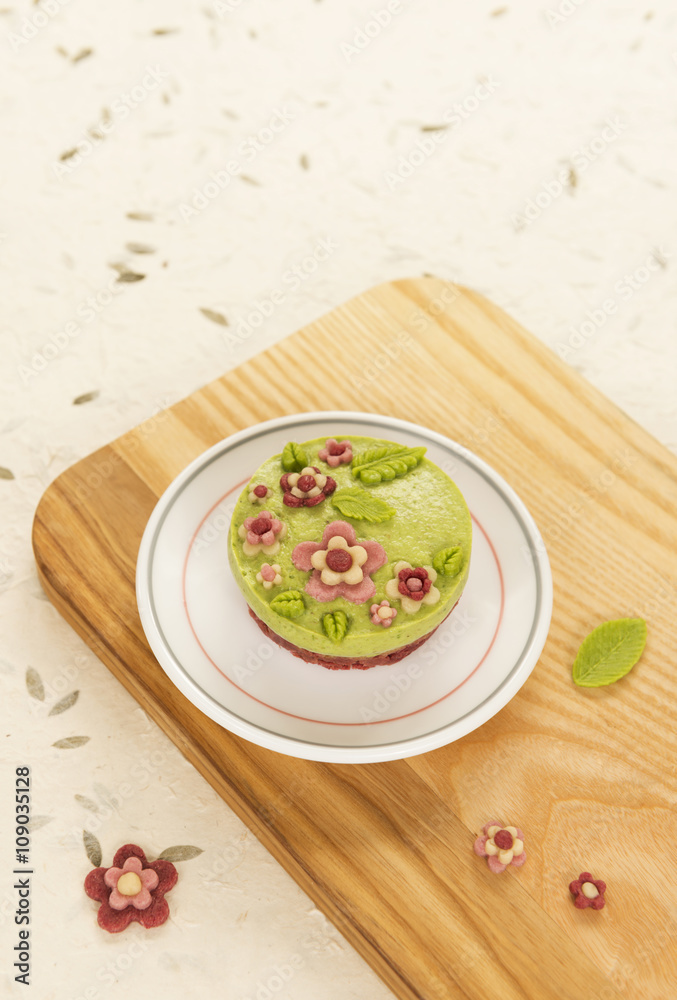 Raw vegan spinach cake with the raw marzipan flowers and leaves Raw vegan spinach cake with the raw marzipan flowers and leaves