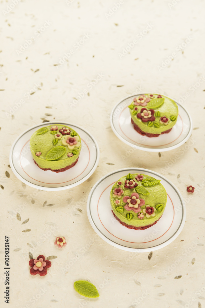 Raw vegan spinach cakes with the raw marzipan flowers and leaves Raw vegan spinach cakes with the raw marzipan flowers and leaves