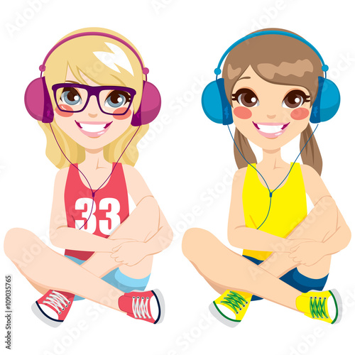 Two lovely teenager girls sitting on floor listening music with headphones together happy smiling