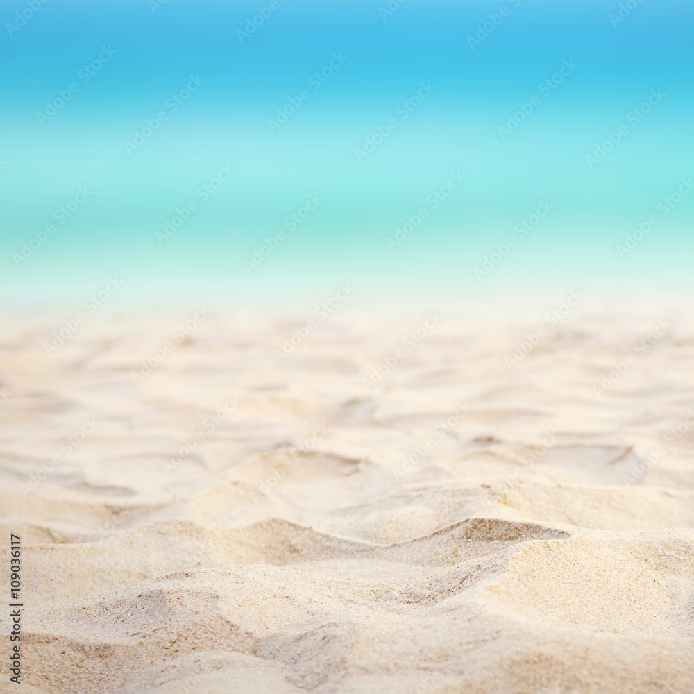 Close up sand with blurred sea sky background, summer day, copy space or for product. Close up sand with blurred sea sky background, summer day, copy space or for product.