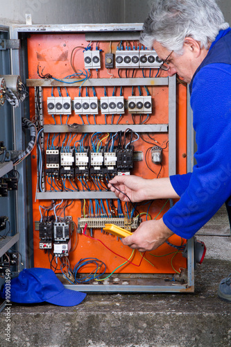 electrician at work with an electric panel