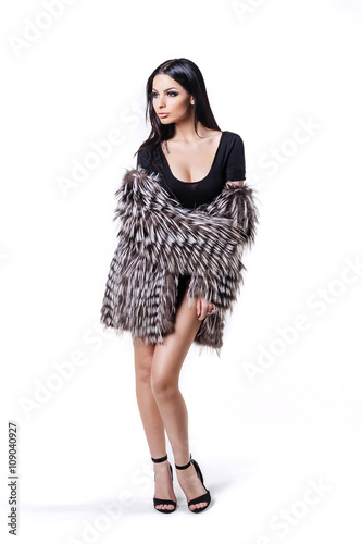 Young beautiful brunette woman in a fur coat