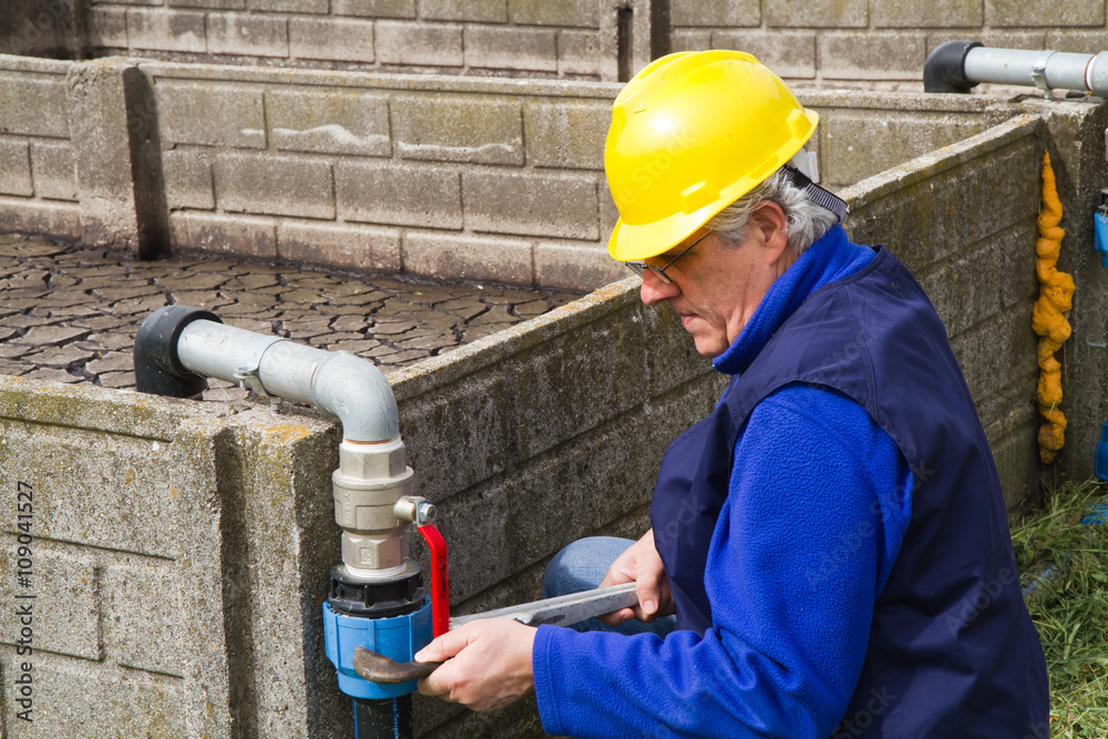 plumber at work in wastewater treatment plant
