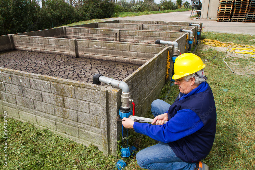 Fototapeta premium plumber at work in wastewater treatment plant