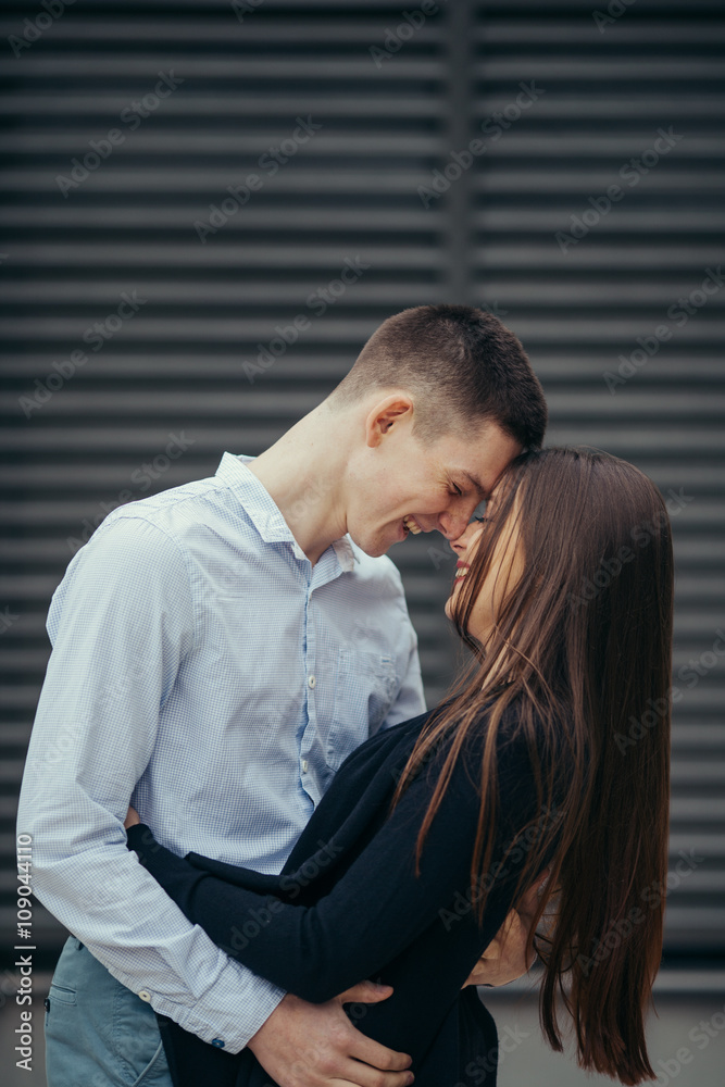 Lovely couple standing on the street and kissing Lovely couple standing on the street and kissing