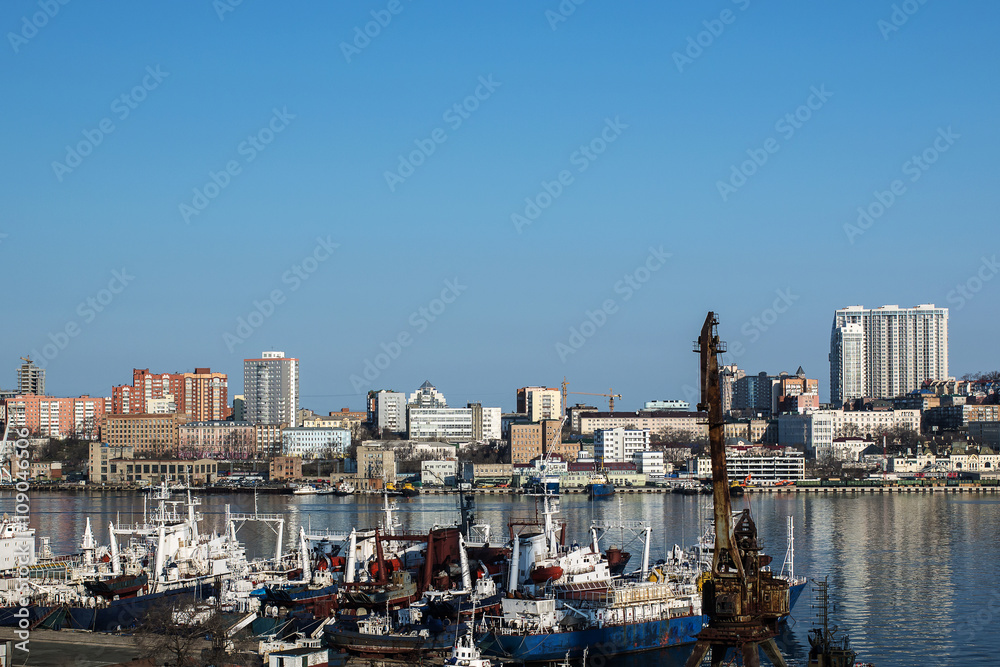 ships moored to the pier on the background of the city of Vladivostok