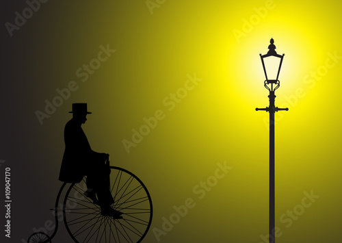 Penny Farthing Gentleman In The Street Light