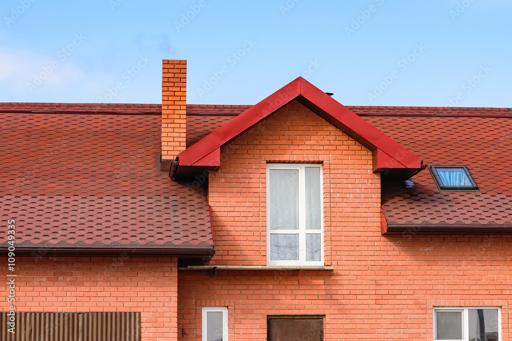 chimney on the roof of the house against the blue sky chimney on the roof of the house against the blue sky