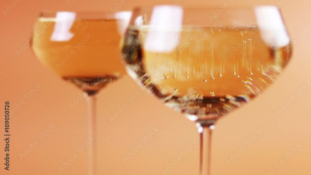 refocusing glasses of champagne on a cream background refocusing glasses of champagne on a cream background