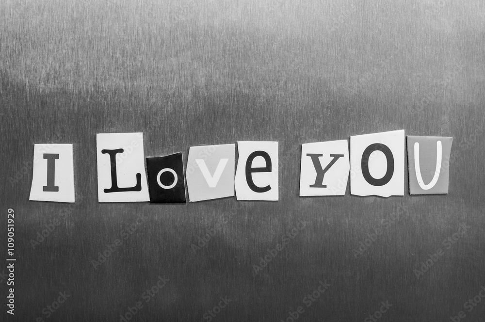 Obraz premium I Love You written with color magazine letter clippings on metal background. Design for relationships, romance, love and Valentines day