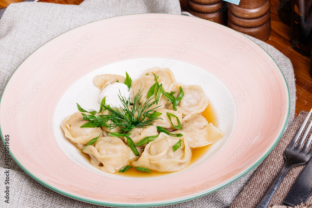 Boiled prepared homemade russian dumplings or pelmeni with beef