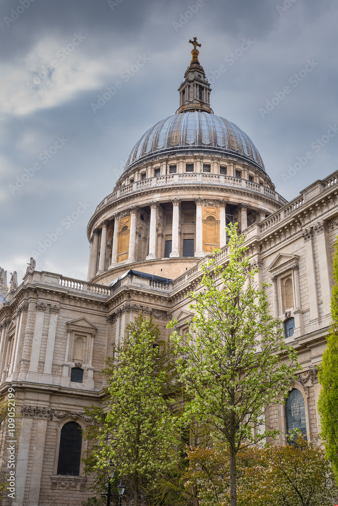 Portrait view of St Paul's Cathedral London with cloudy sky.