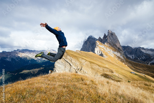 A young boy jumps for joy in scenic mountains