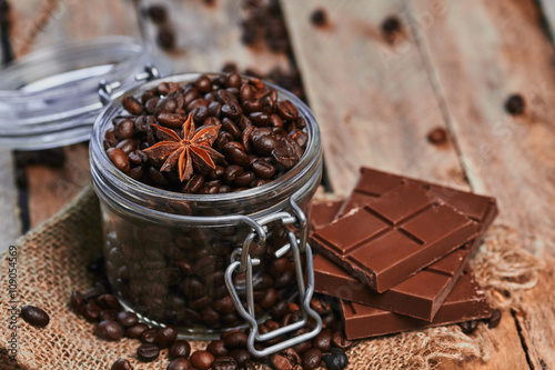 Coffee beans, chocolate and star anise in jar