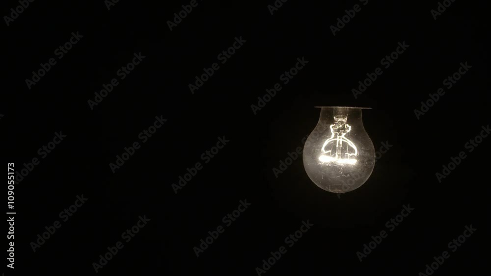 Glowing hanging light bulb dangle on a wire Glowing hanging light bulb dangle on a wire