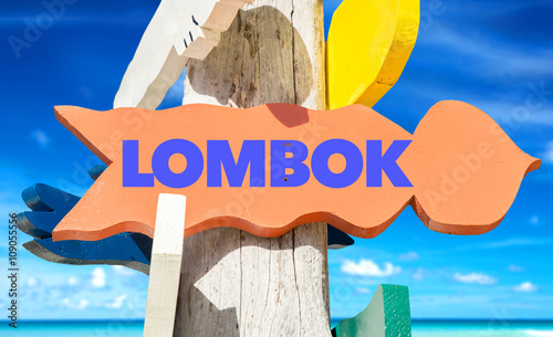 Lombok signpost with beach background photo